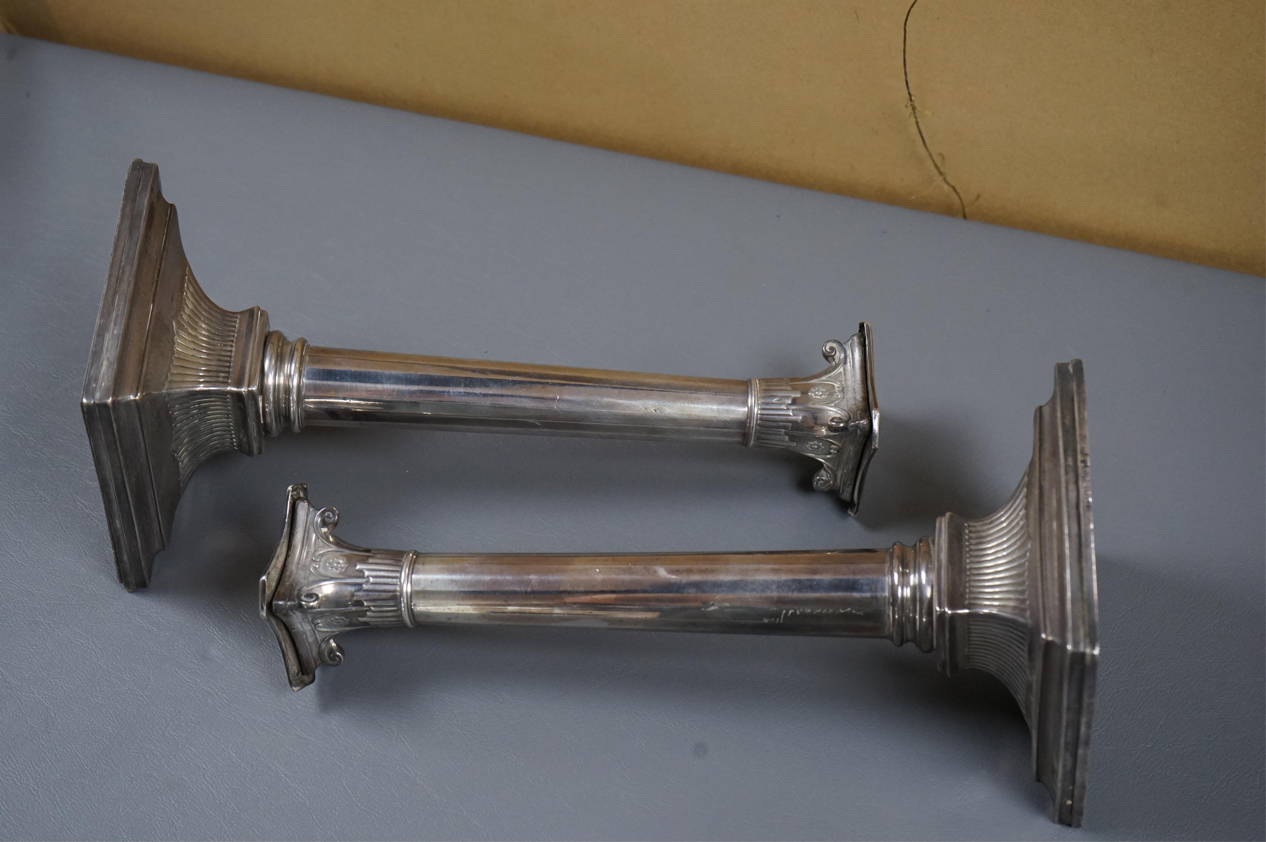 A pair of George III silver candlesticks by Luke Proctor & Co, with panelled stems(worn), on square bases with two engraved armorials, Sheffield, 1786, height 17.4cm, weighted (a.f.).